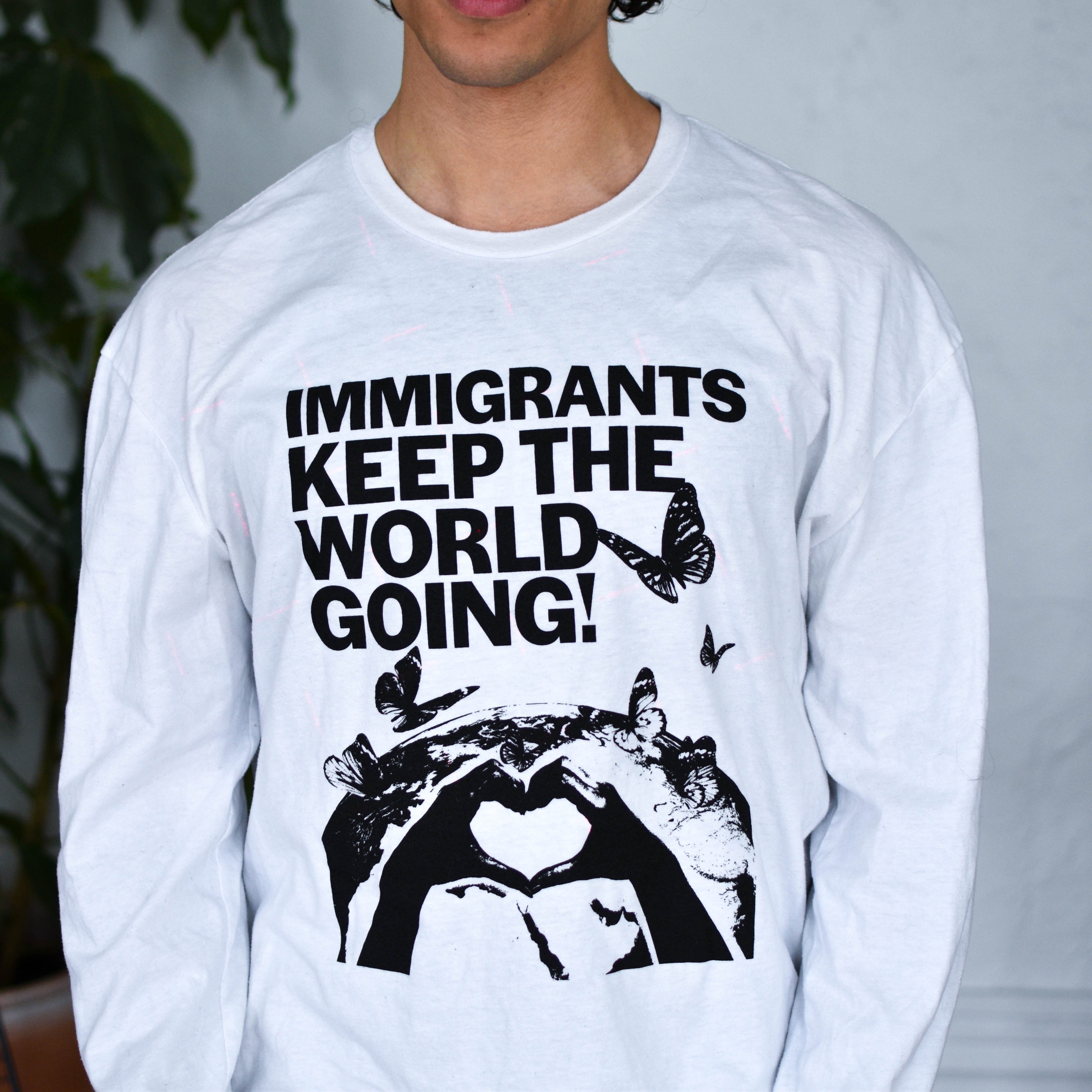 White Long Sleeve Shirt - "Immigrants Keep the World Going" Solidarity Merch