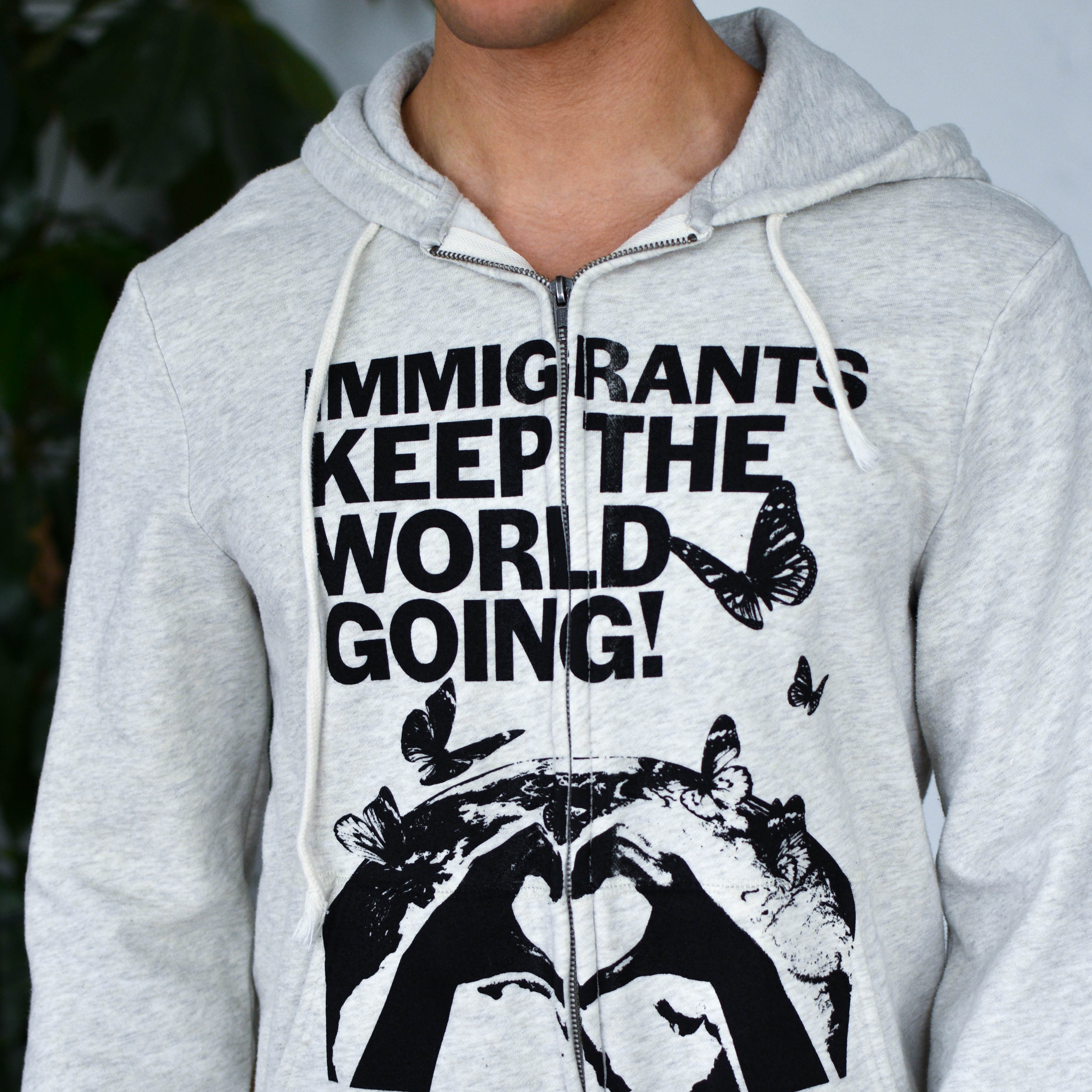 Gray Zip-Up Sweatshirt "Immigrants Keep the World Going" Solidarity Merch