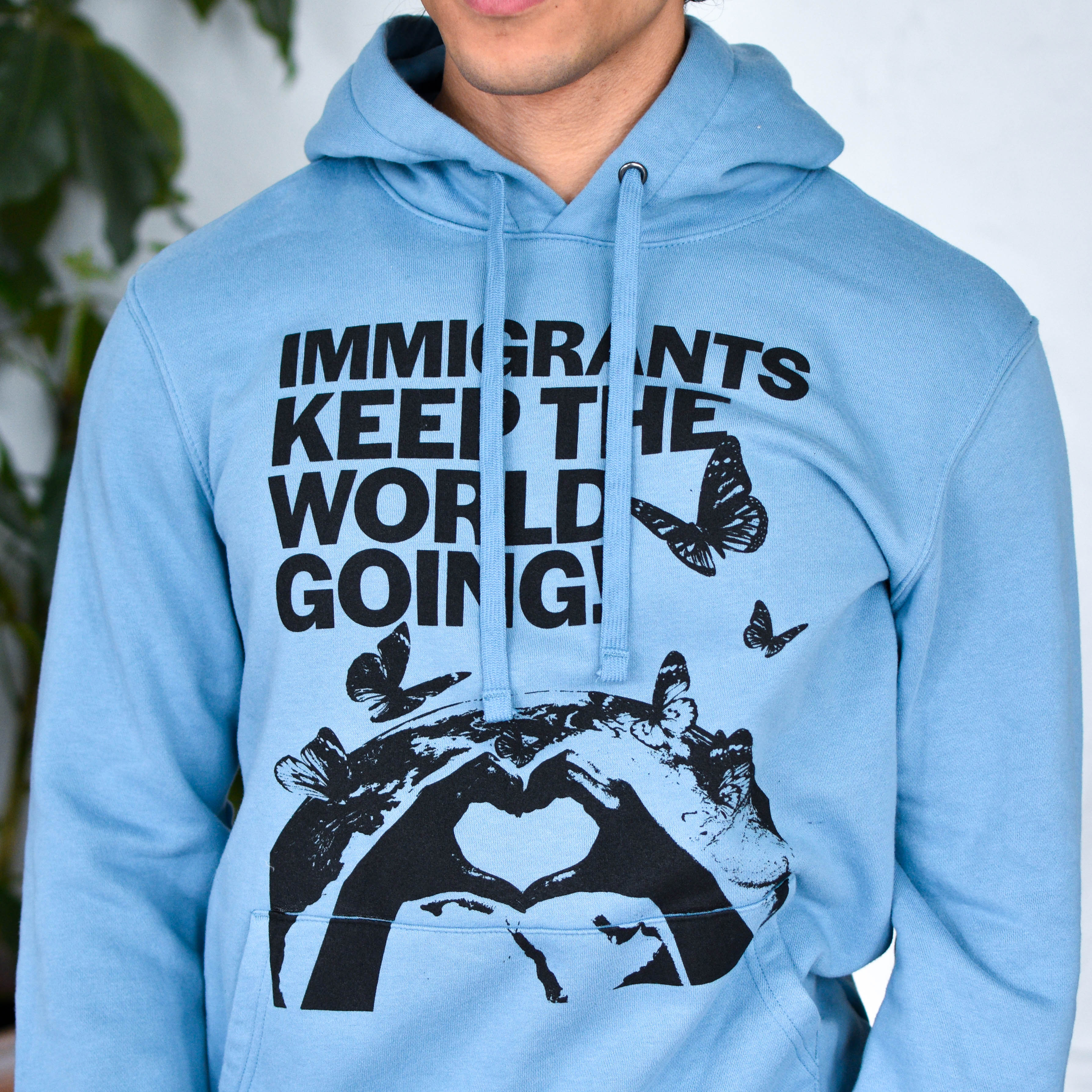 Light Blue Hoodie "Immigrants Keep the World Going" Solidarity Merch