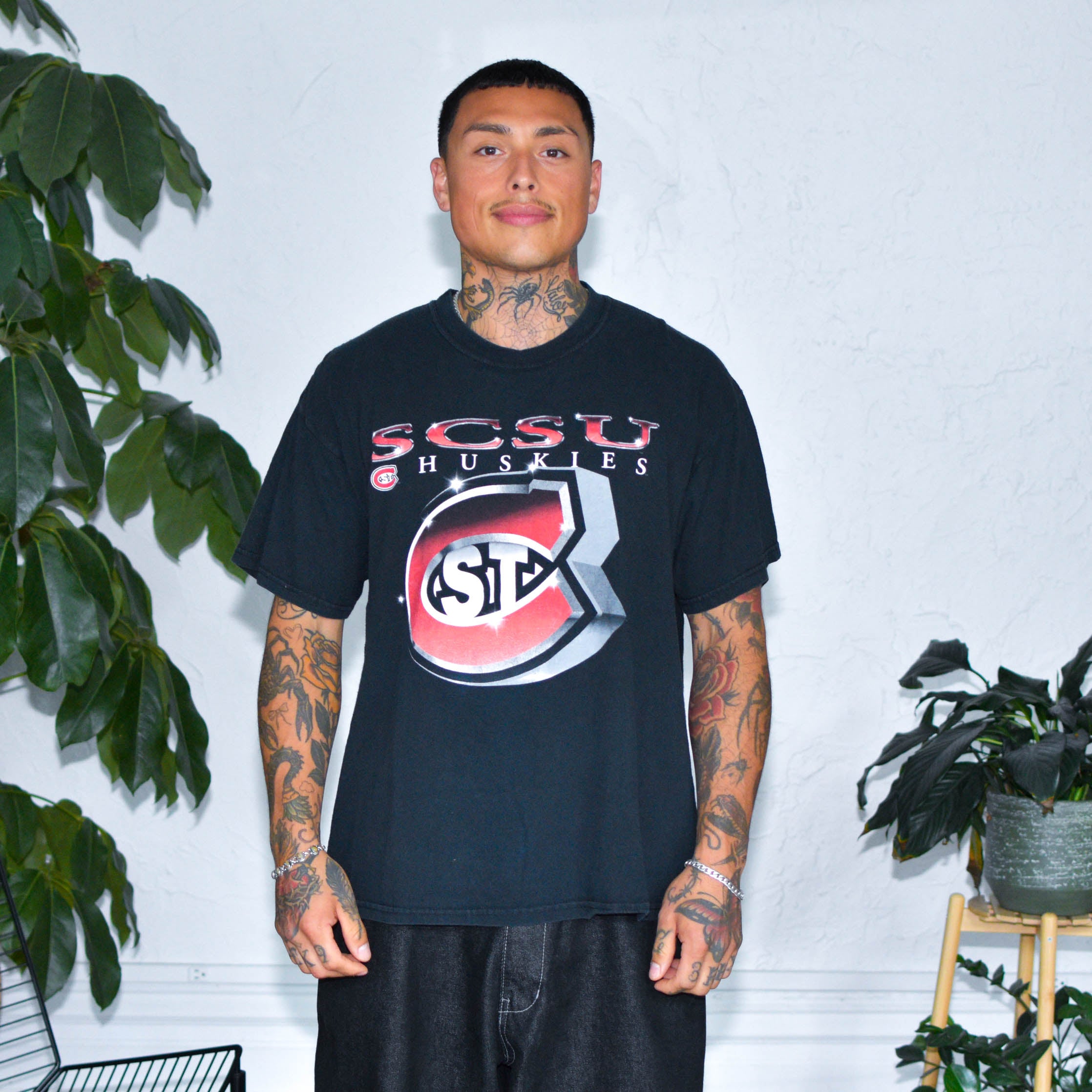 Model Wearing Vintage St. Cloud State University Black Graphic T-Shirt from Bro Bros Closet