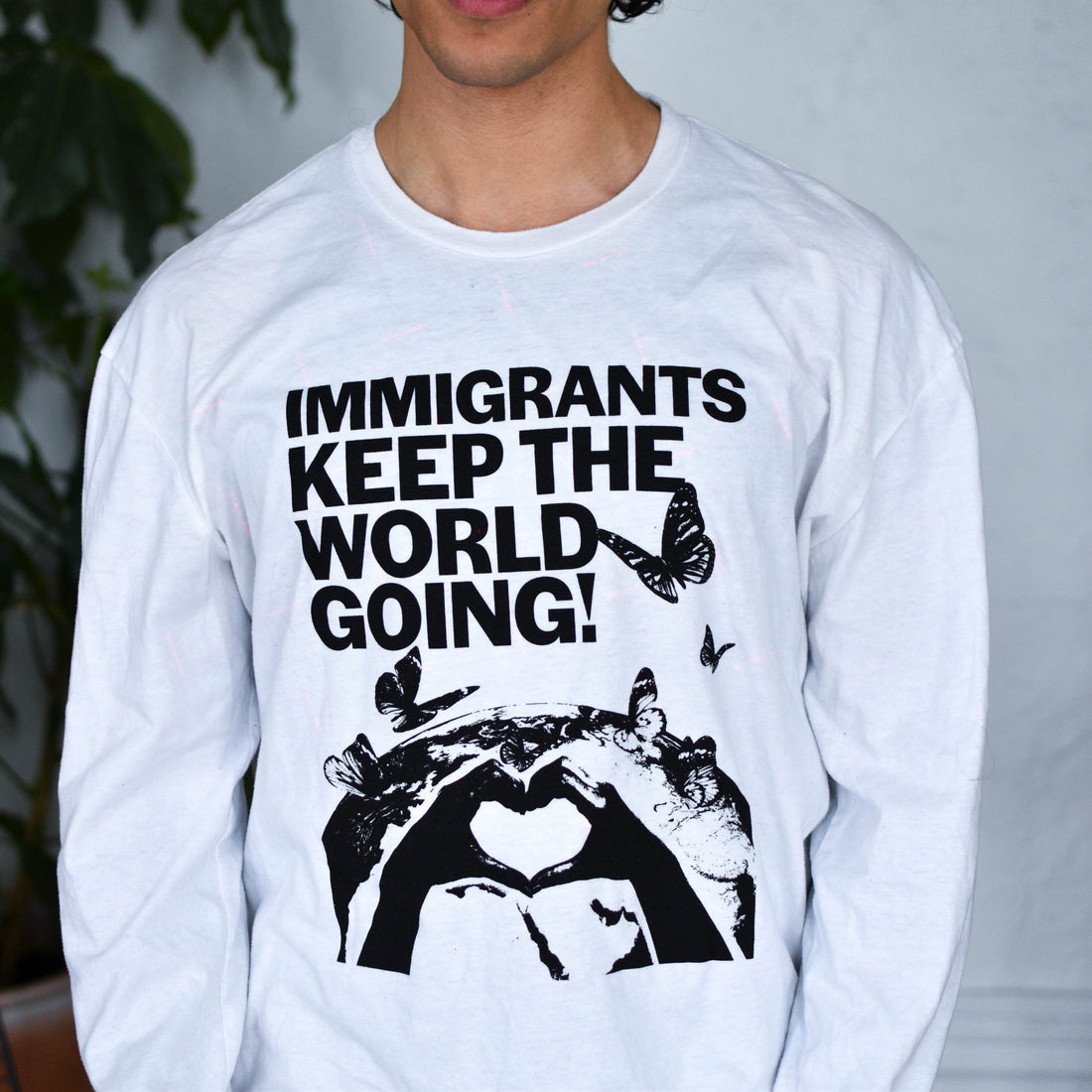 White Long Sleeve Shirt - "Immigrants Keep the World Going" Solidarity Merch