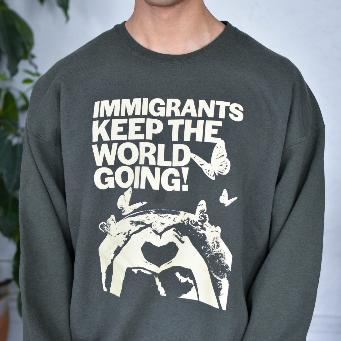 Green Sweatshirt "Immigrants Keep the World Going" Solidarity Merch