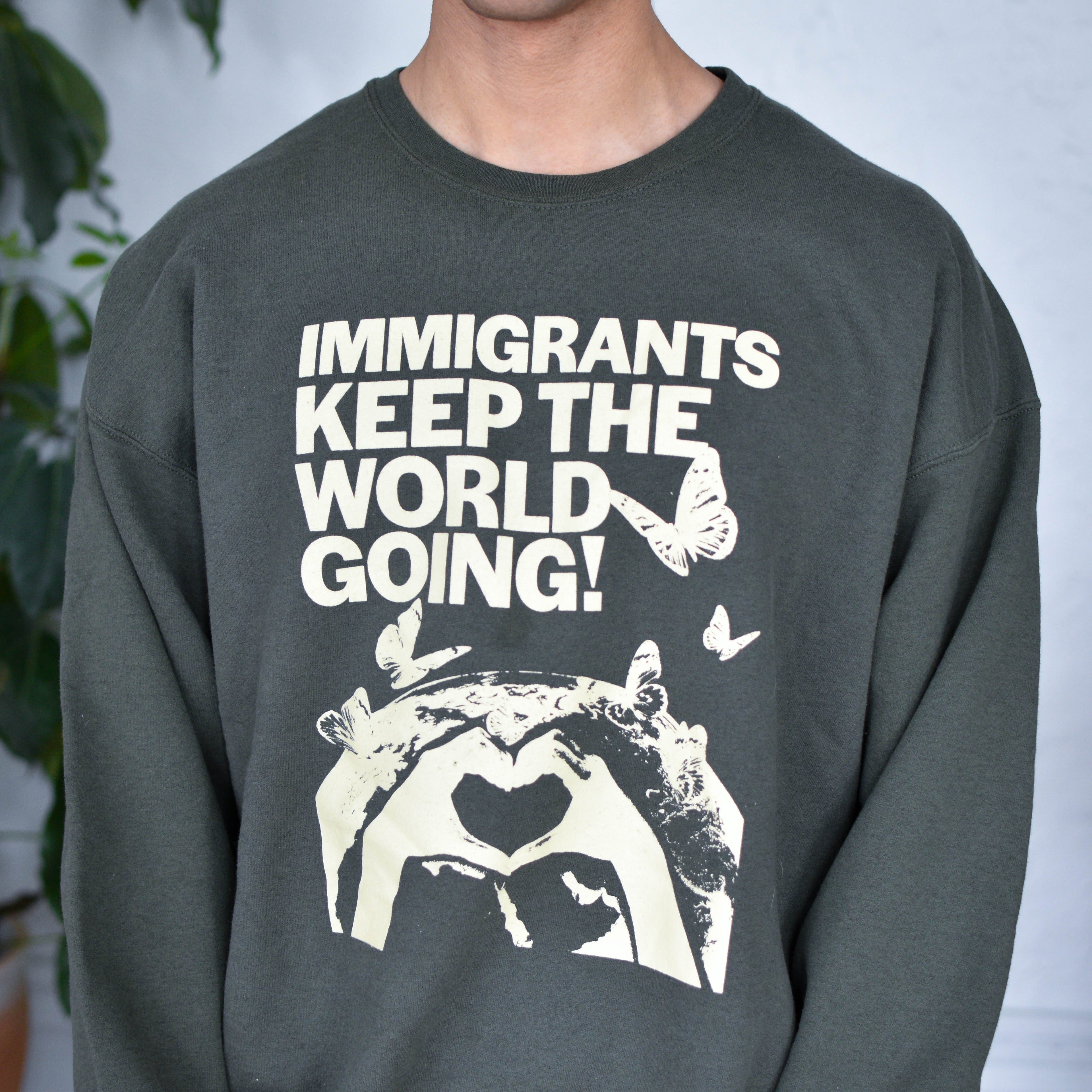 Green Sweatshirt "Immigrants Keep the World Going" Solidarity Merch