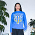 Model wearing a vintage crewneck sweatshirt from 1999 that has kurt warner, Marshall Faulk, and Isaac Bruce